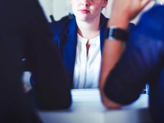 Woman waiting for moment to speak at a meeting