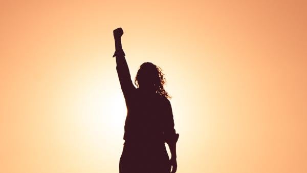 woman raises fist