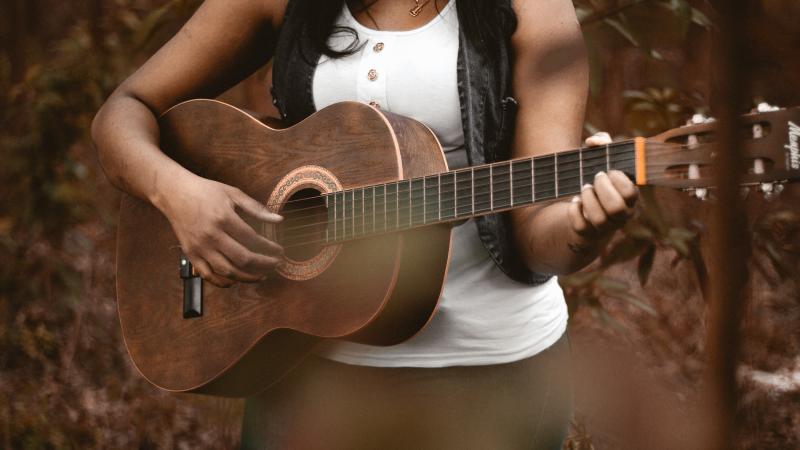 a woman plays guitar