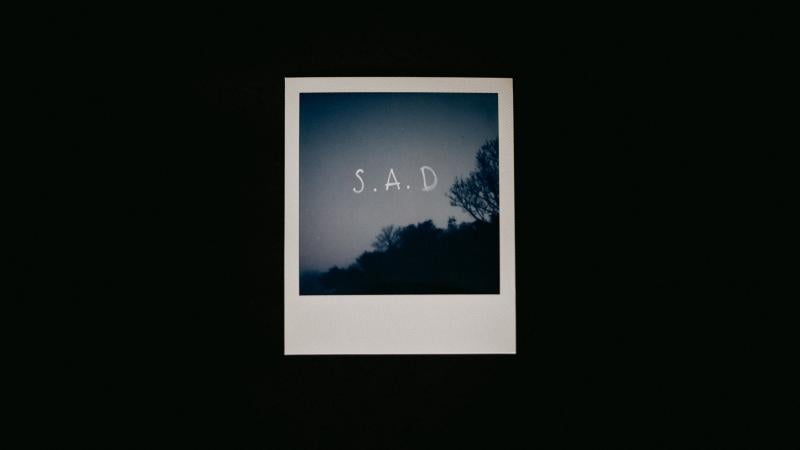 a photograph with the letters SAD printed on it