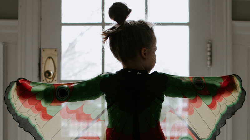 a girl making butterfly wings