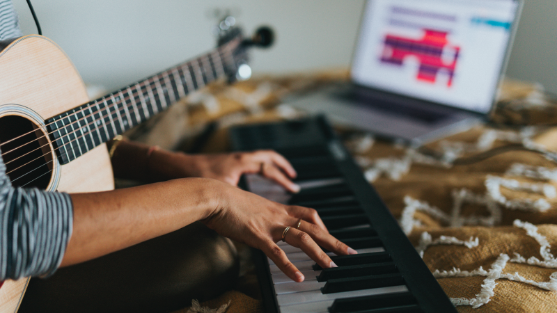 making music on a piano and a guitar